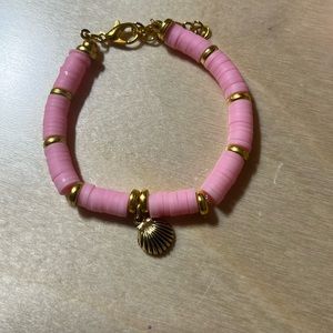 Gold and pink bracelet with seashell charm